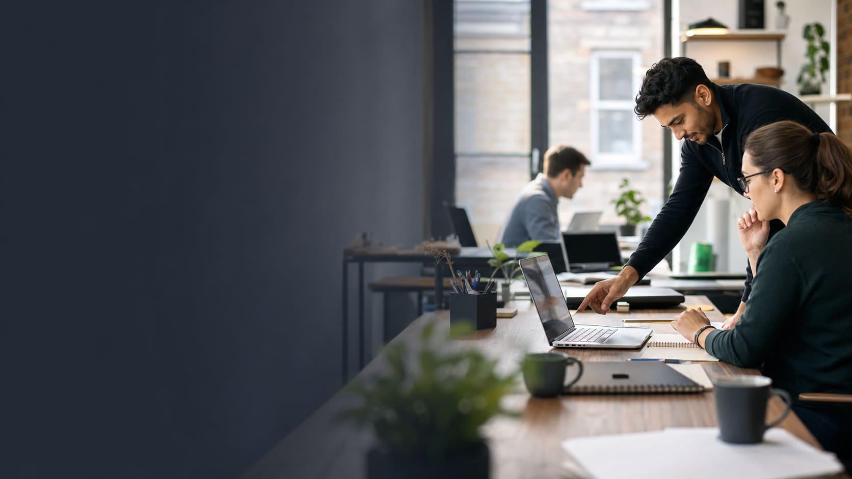 IT engineer helping a small London office team with laptop and Wi-Fi support